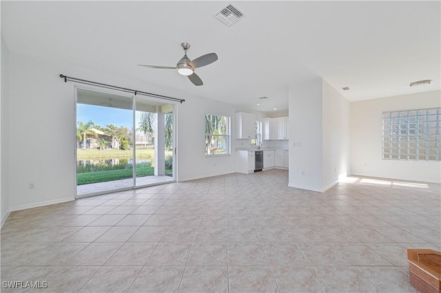 unfurnished living room with ceiling fan and light tile patterned floors