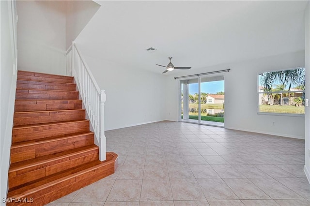 stairs with tile patterned floors and ceiling fan