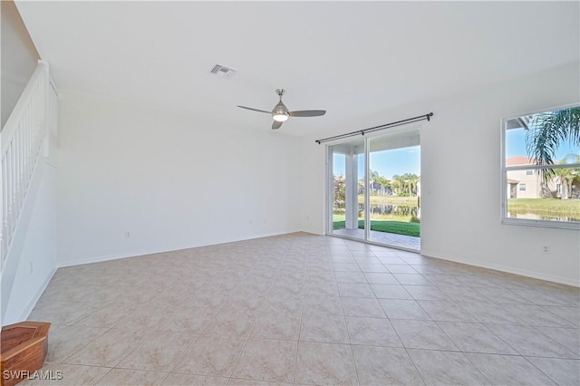 unfurnished room with ceiling fan and light tile patterned floors