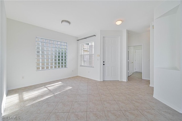 spare room featuring light tile patterned floors