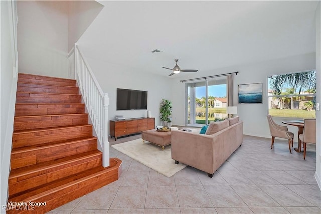 tiled living room featuring ceiling fan