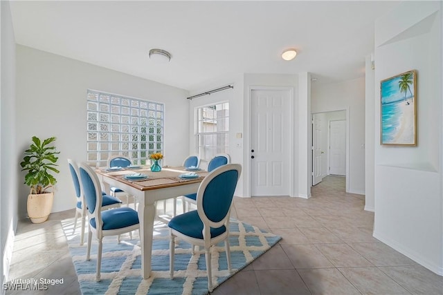 dining space featuring light tile patterned floors