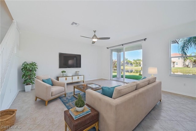 living room with ceiling fan and light tile patterned flooring