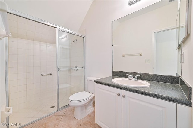 bathroom featuring vanity, vaulted ceiling, tile patterned flooring, toilet, and walk in shower