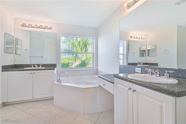 bathroom with tile patterned flooring, vanity, and a tub to relax in