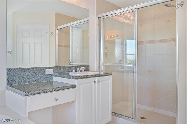 bathroom featuring vanity, an enclosed shower, and tasteful backsplash