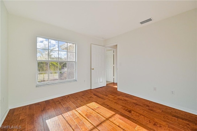 spare room featuring wood-type flooring