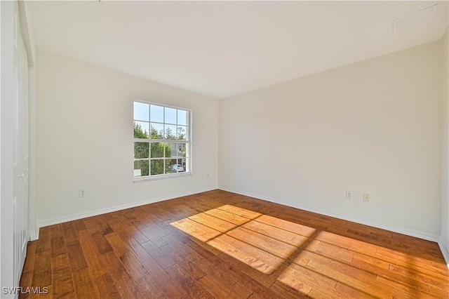 spare room featuring hardwood / wood-style floors