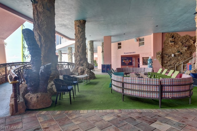 view of patio / terrace with an outdoor living space with a fireplace