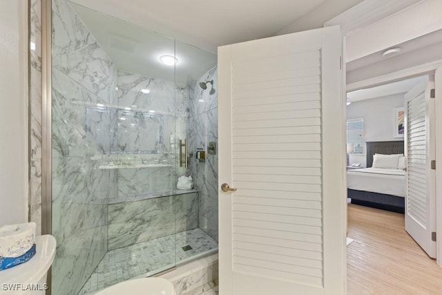 200 Estero Blvd Unit 101, Fort Myers Beach, FL 33931 - ensuite bathroom featuring toilet, wood finished floors, a marble finish shower, and ensuite bathroom