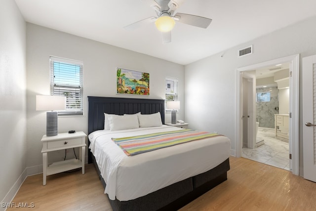 bedroom featuring light hardwood / wood-style floors, connected bathroom, and ceiling fan