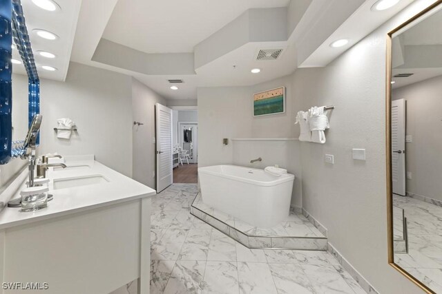 bathroom featuring vanity and a washtub