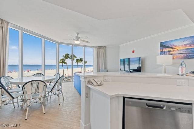 200 Estero Blvd Unit 101, Fort Myers Beach, FL 33931 - kitchen featuring light countertops, a wall of windows, light wood-style floors, a ceiling fan, and stainless steel dishwasher