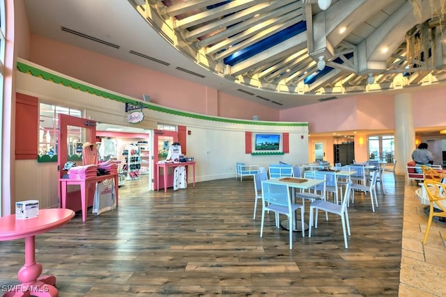 200 Estero Blvd Unit 101, Fort Myers Beach, FL 33931 - dining area with wood finished floors, visible vents, and a towering ceiling