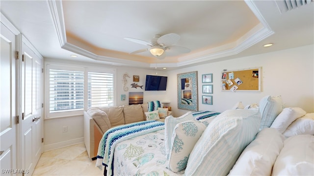 bedroom with ornamental molding, ceiling fan, and a raised ceiling