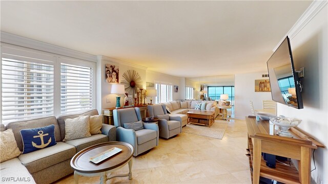 living room with a healthy amount of sunlight and crown molding