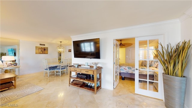 living room featuring french doors, a notable chandelier, and ornamental molding