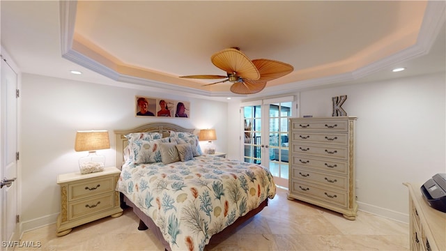 bedroom with ornamental molding, a tray ceiling, french doors, and ceiling fan