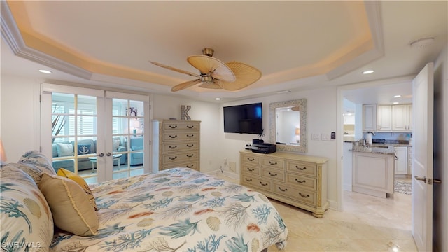 bedroom featuring ceiling fan, a raised ceiling, and sink