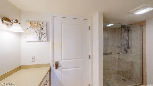 bathroom featuring vanity and a shower with shower door