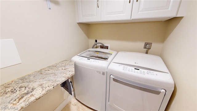 laundry area with cabinets and washer and clothes dryer