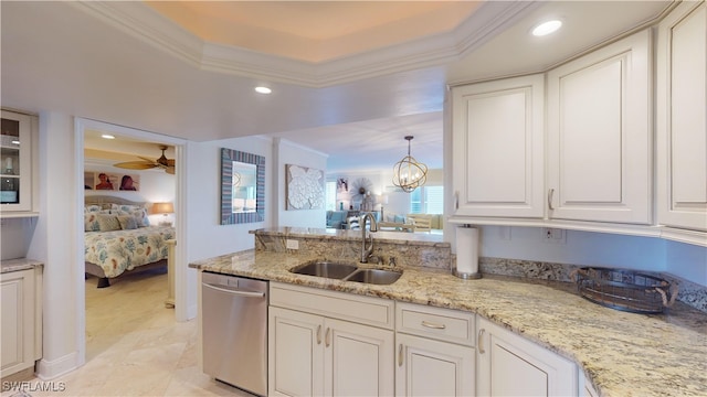 kitchen featuring sink, a tray ceiling, hanging light fixtures, crown molding, and dishwasher