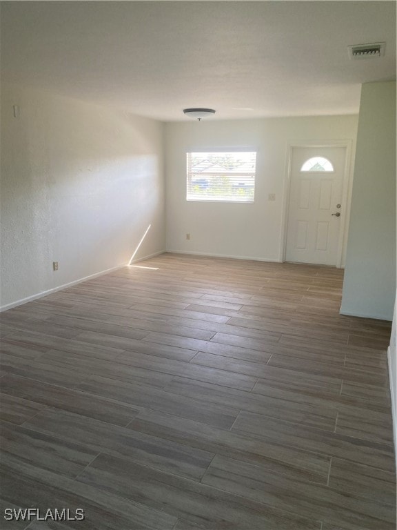 foyer featuring wood finished floors and visible vents