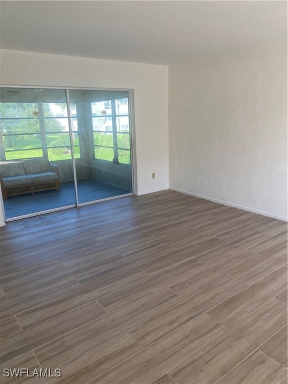 spare room featuring wood finished floors