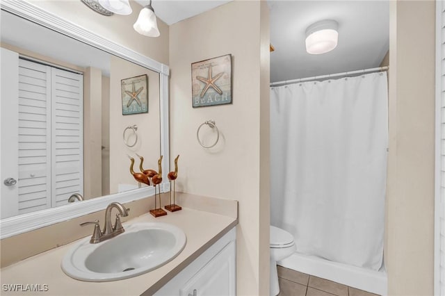 bathroom with tile patterned floors, curtained shower, vanity, and toilet