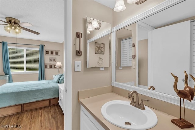 bathroom featuring vanity, hardwood / wood-style flooring, and ceiling fan