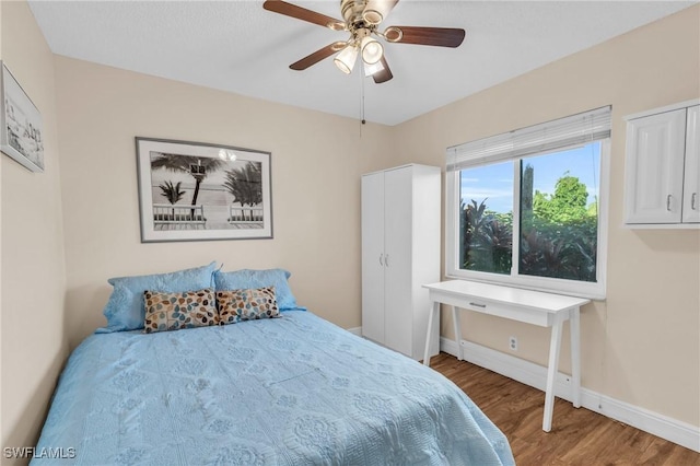 bedroom with wood-type flooring and ceiling fan