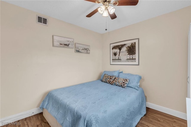 bedroom with hardwood / wood-style floors and ceiling fan