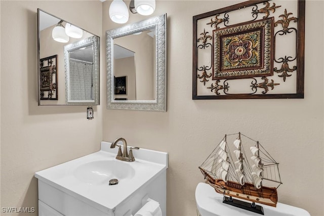 bathroom with vanity and toilet