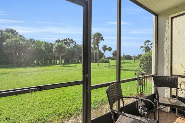 4318 27th Ct SW Unit 102, Naples, FL 34116 - sunroom / solarium featuring view of scattered trees
