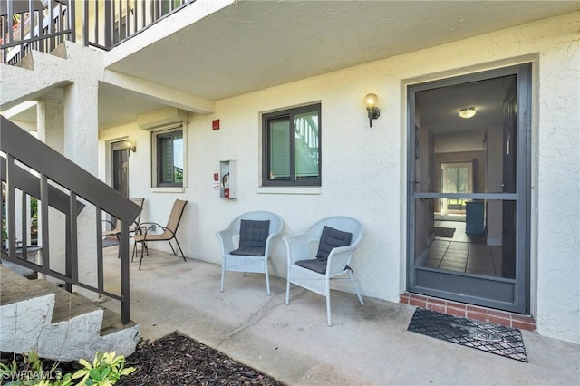 4318 27th Ct SW Unit 102, Naples, FL 34116 - property entrance featuring stucco siding and a patio area