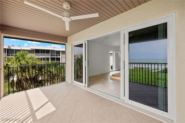 exterior space featuring ceiling fan, wood ceiling, and a water view