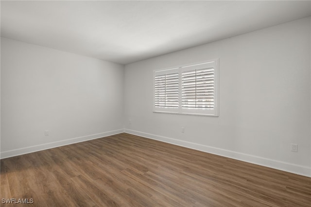 spare room with dark hardwood / wood-style floors