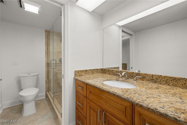 bathroom with tile patterned flooring, vanity, toilet, and a shower with shower door