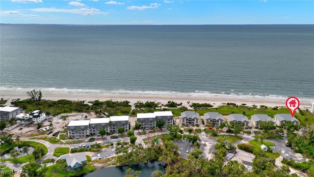 birds eye view of property featuring a beach view and a water view