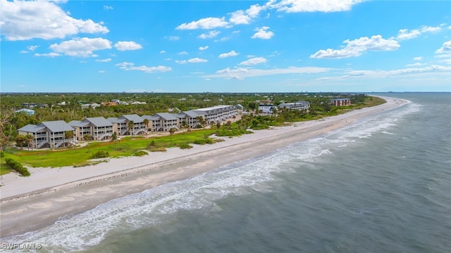 birds eye view of property with a water view and a view of the beach