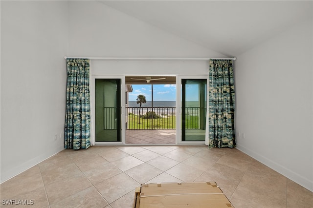 tiled empty room with lofted ceiling