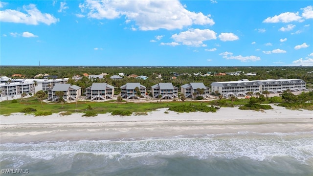 birds eye view of property featuring a beach view and a water view