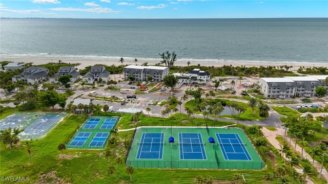 bird's eye view featuring a water view and a beach view