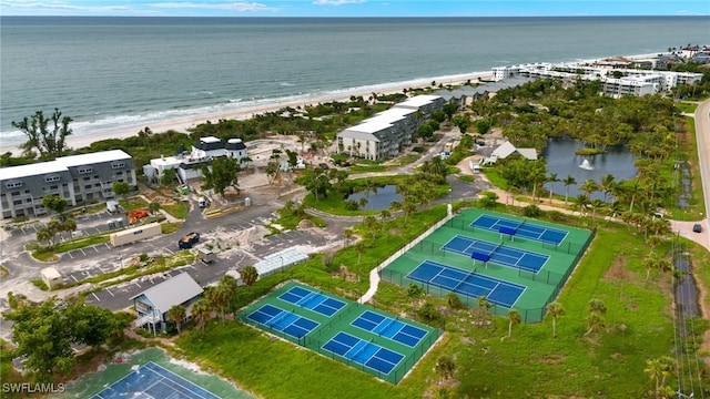 aerial view with a water view and a beach view