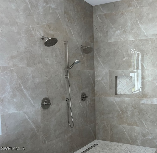 bathroom with a tile shower