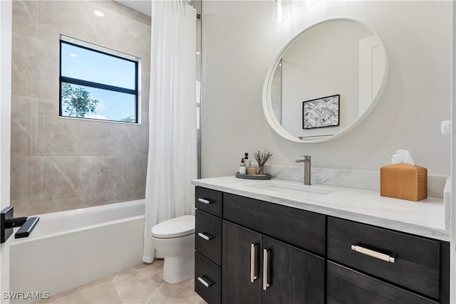 full bathroom featuring toilet, vanity, shower / bath combo with shower curtain, and tile patterned floors