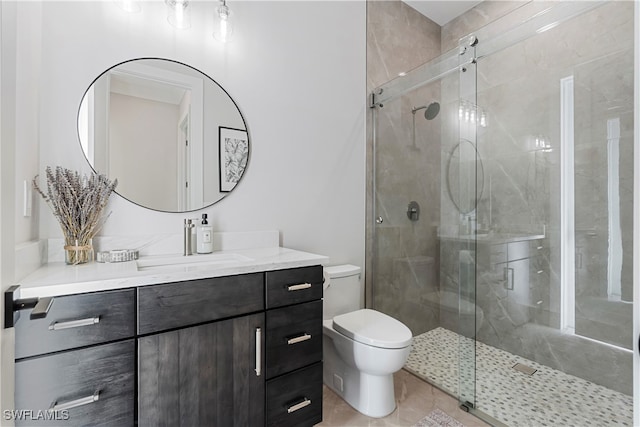 bathroom featuring toilet, tile patterned floors, vanity, and a shower with door