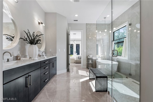 bathroom with independent shower and bath and vanity