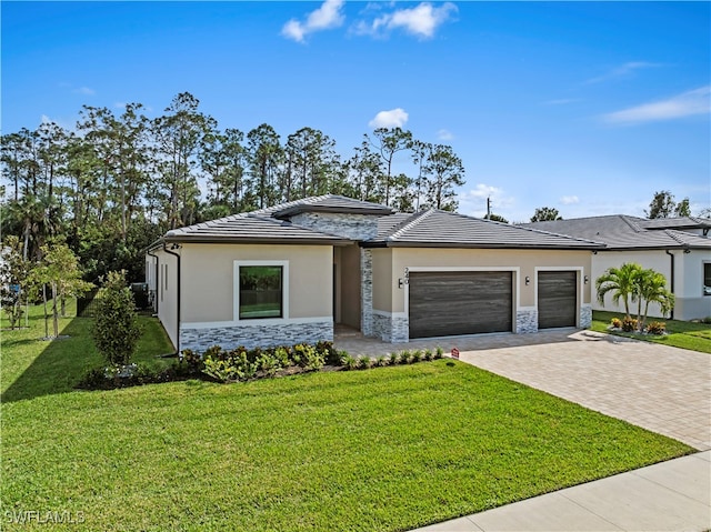 view of front of home with a garage and a front yard