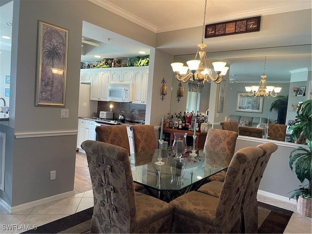 dining room with crown molding, sink, light tile patterned floors, and a chandelier